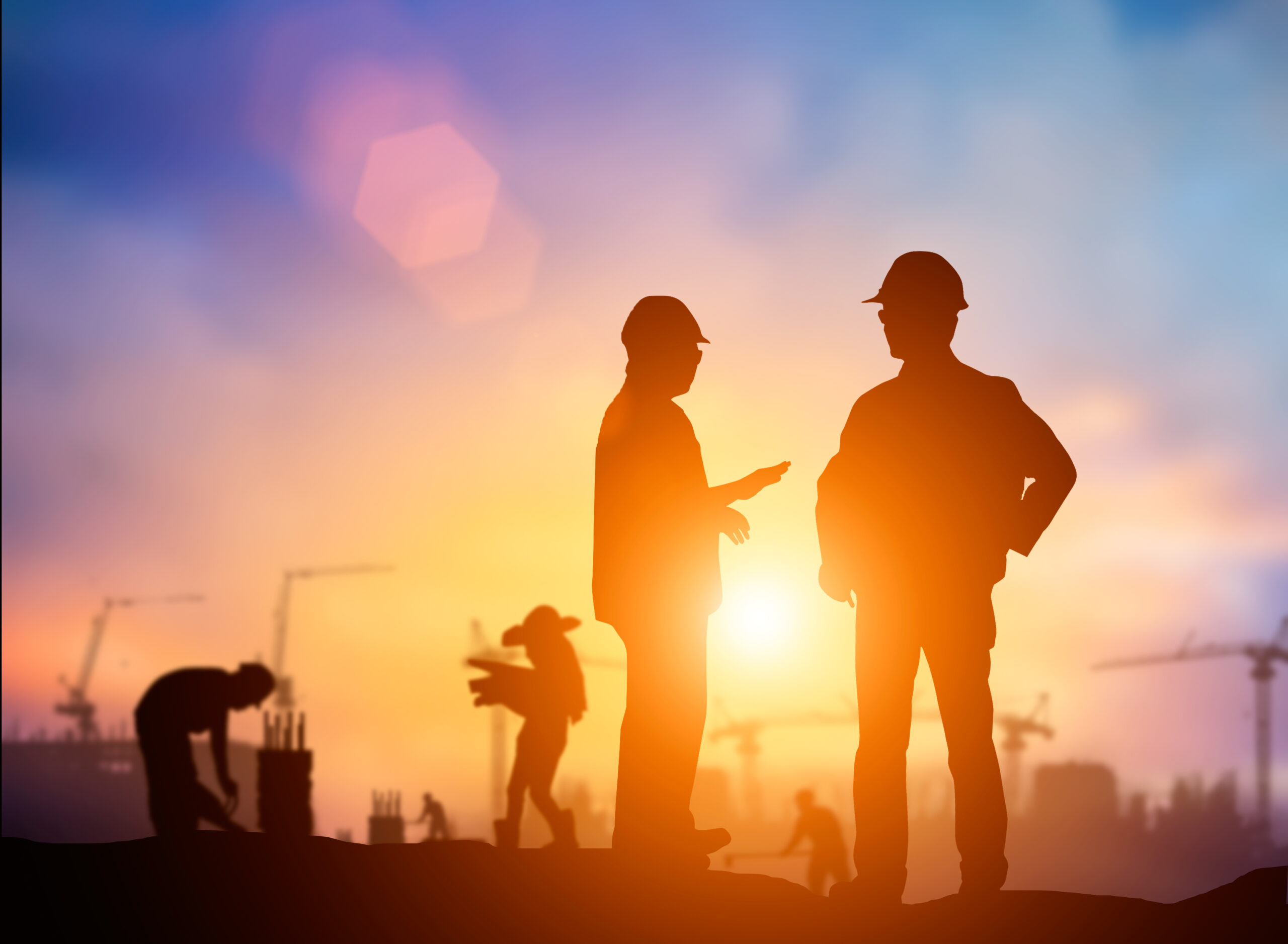 silhouette engineer looking Loaders and trucks in a building sit